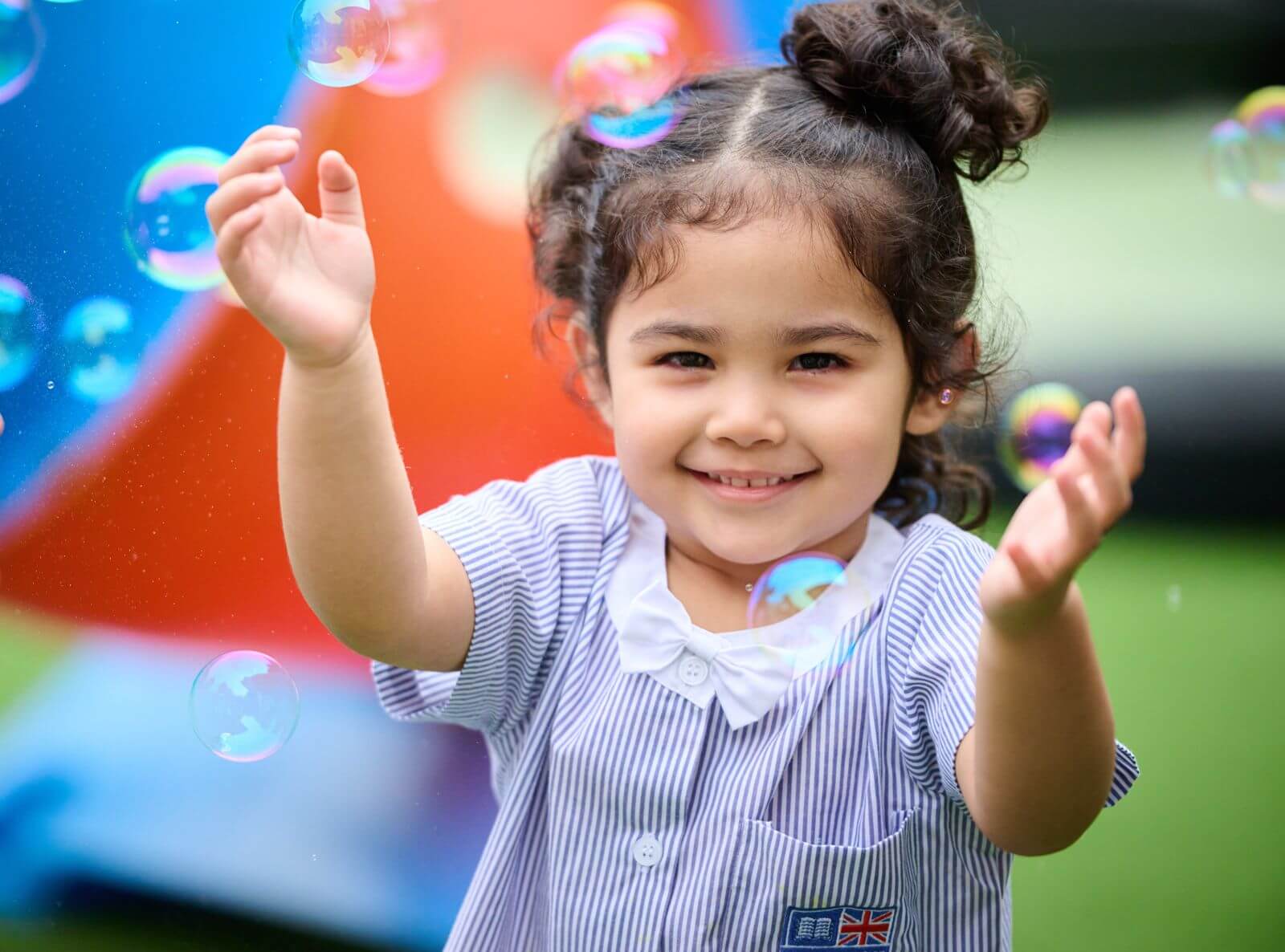 Early Years child playing with bubbles at St. Andrews International School Sathorn